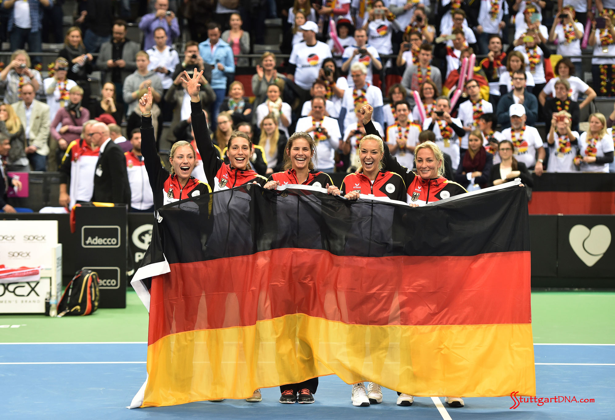 Porsche Team Germany in Fed Cup semi-final Porsche Team Germany in Fed Cup semi-final: Seen here is the triumphant Porsche Team Germany team holding a large flag of Deutschland at Porsche Arena, 2015, after defeating Australia, now moving on to the Fed Cup Semi-Finals. Credit: Porsche AG