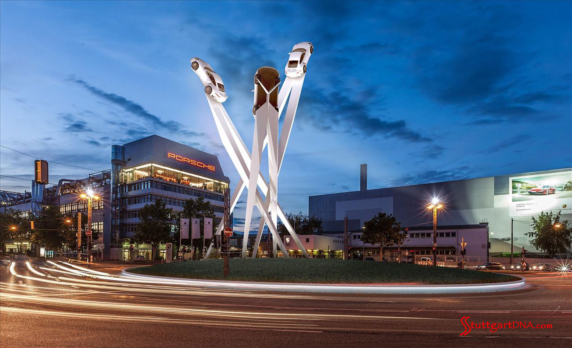 Porsche SE 2014 group profit 2 billion euro Porsche SE 2014 group profit 2 billion euro: A wide-angle nighttime shot of Porscheplatz, the Porsche Factory and the towering draft of a centerpiece sculpture, Stuttgart. Credit: Porsche AG