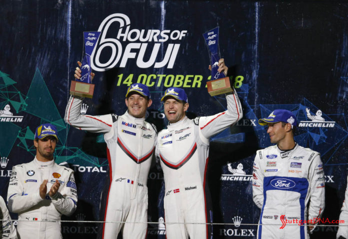 Estre and Christensen atop 2018 WEC Fuji 6 Hrs podium. Credit: Porsche AG Porsche wins 2018 WEC Fuji 6 Hours: Seen here are the ecstatic, victorious Kevin Estre and Michael Christensen (l-r) at the top of the 2018 WEC Fuji 6 Hrs GTE-Pro podium. Credit: Porsche AG