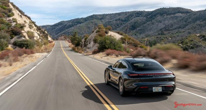 Taycan 4S, left-rear, on mountain road. Credit: Porsche AG 2020 Porsche USA sales: Pictured here is a Taycan 4S, from the left-rear, cruising down a mountain road. Credit: Porsche AG