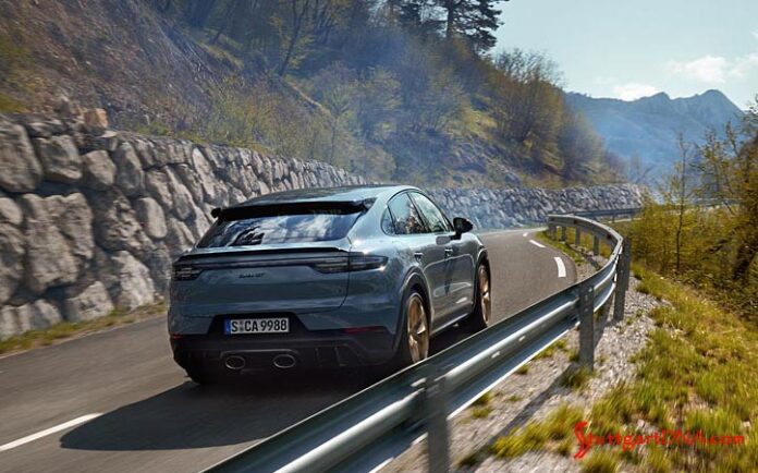 Porsche AG half-year 2021 worldwide sales: Depicted here is a Cayenne Turbo GT, seen from its right-rear corner, careening down a scenic mountain road. Credit: Porsche AG