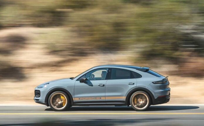 Cayenne - PCNA Q2 2022 Sales. Credit: Porsche AG PCNA Q2 sales: Depicted here is a Cayenne, seen from its left, careening down a scenic road. Credit: Porsche AG
