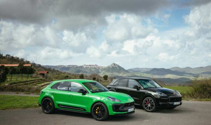 Green and Black Cayennes. Credit: Porsche AG Depicted in the image are two green and black Cayennes against the backdrop of countryside and several mountain peaks in deep b.g. Credit: Porsche AG