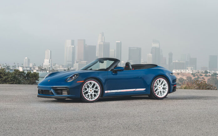 Blue 911 GTS Cabriolet America set against L.A. skyline. Credit: Porsche AG Porsche recalls 911 for seat-belt retractor issues: Depicted here in this picturesque image is a Blue 911 GTS Cabriolet America set against the L.A. skyline above Dodger Stadium. Credit: Porsche AG
